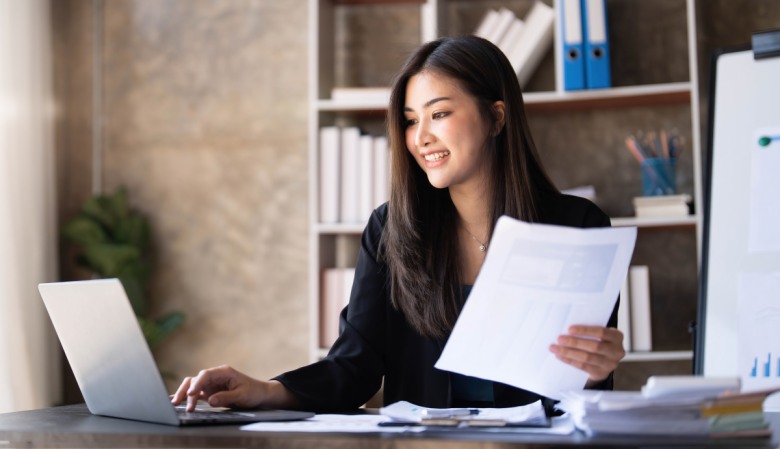 Business woman using calculator for do math finance on wooden desk in office and business working background, tax, accounting, statistics and analytic research concept.